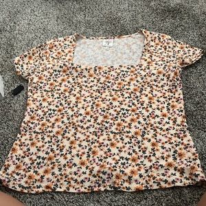 A flower shirt, with square neck, it’s a size large and the brand is self esteem